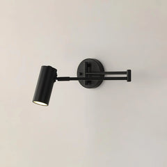 Modern black swing arm wall sconce with cylindrical head and warm light on white wall