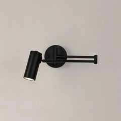 Modern black metal swing arm wall lamp with cylindrical head and warm light on beige background