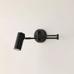 Modern black swing arm wall lamp with adjustable cylindrical shade on white wall