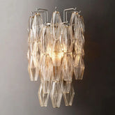Modern Murano clear glass wall sconce with geometric design, illuminated on gray wall