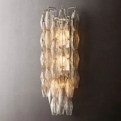 Modern Murano clear glass wall sconce with geometric panels, lit on a dark background at YH Lamps