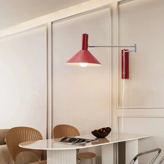 Modern red wall lamp with adjustable arm and white shade, mounted above a dining table in a contemporary interior.