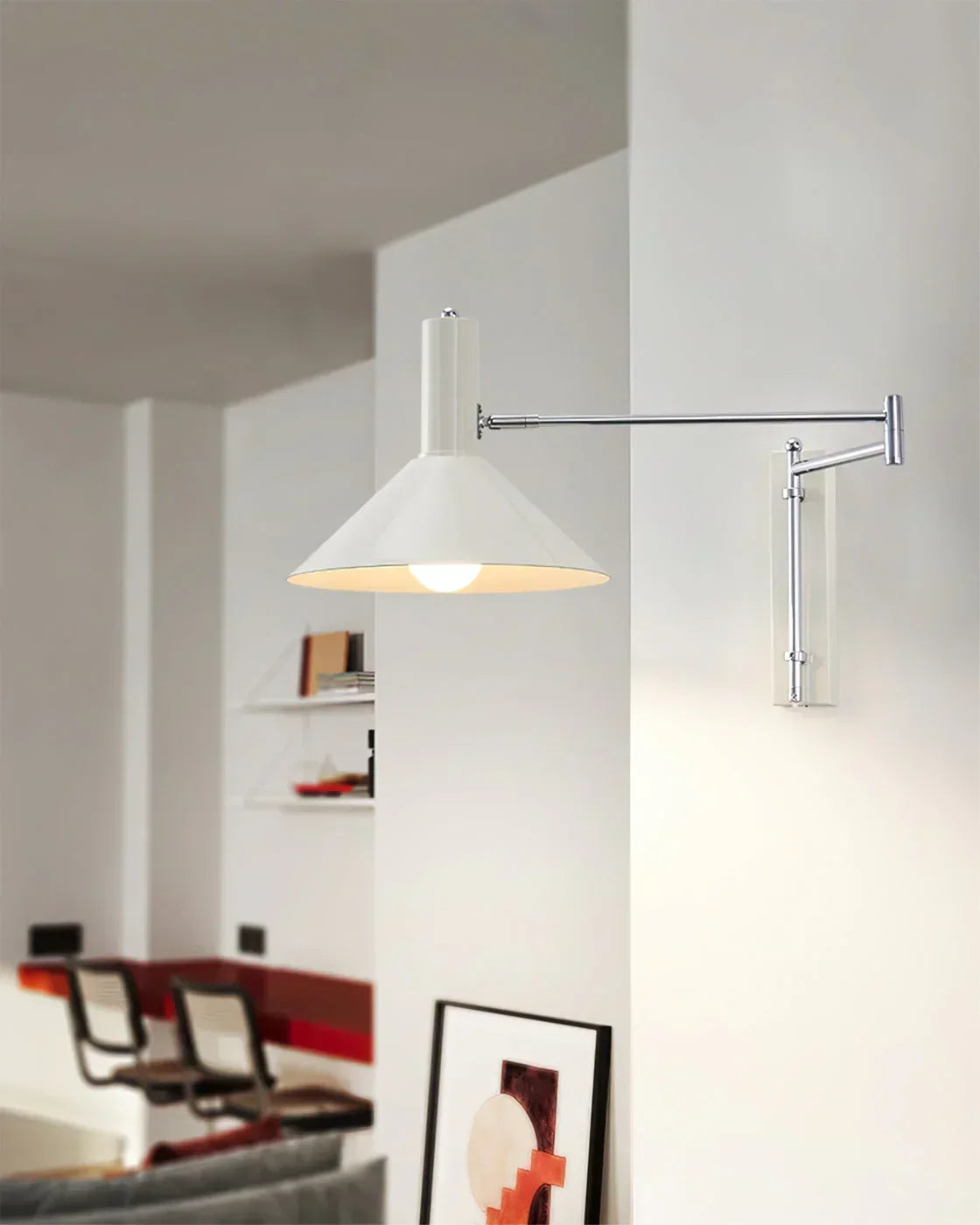 Modern white wall lamp with adjustable arm in a minimalist living room setting