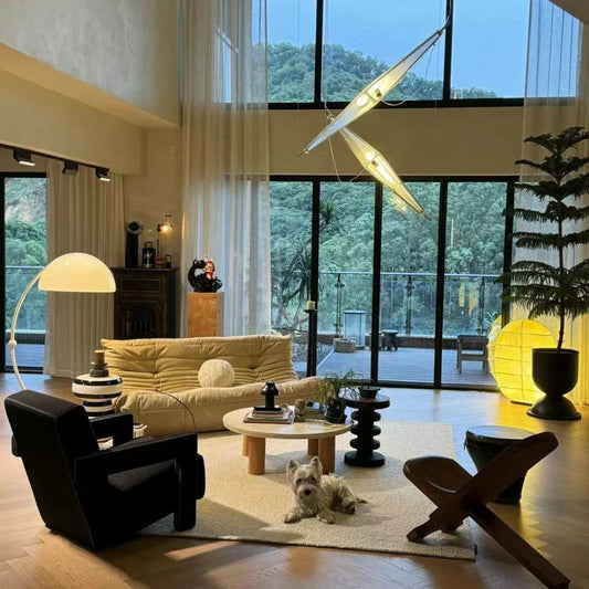 Modern living room with designer chandelier, floor lamp, and luxury seating by YH Lamps.